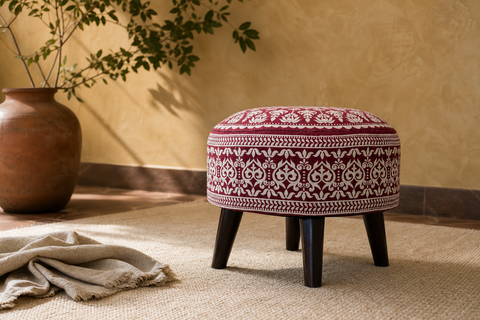 Cherry-red mandala wooden tuffet styled in a warm contemporary living room