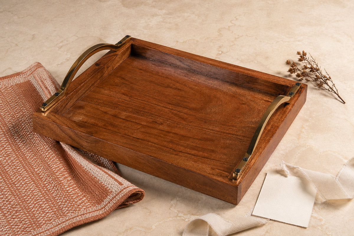 Wooden serving tray with curved brass handles styled as a thoughtful housewarming gift